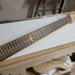 Fretboard with Beveled Frets